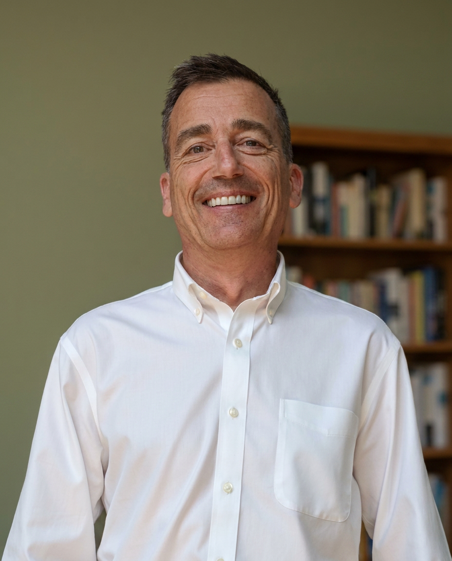 John Windisman, founder of Optimistic Brain, in front of a bookshelf
